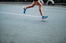Runner mid-stride on a city road